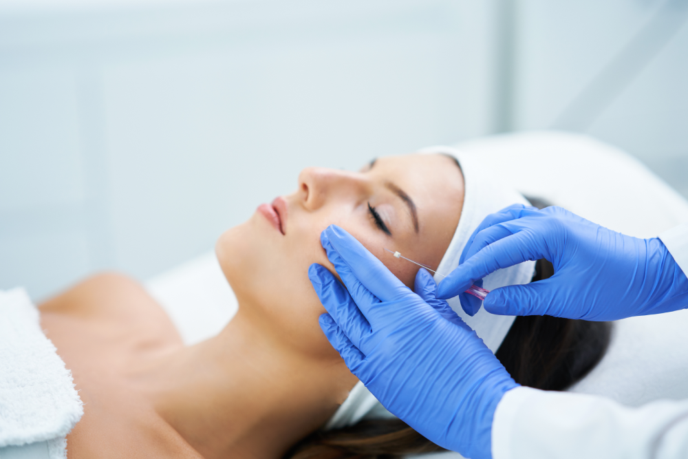 Specialist performing PDO Threads procedure on a woman's face.