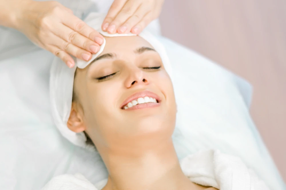 Woman preparing for a facial chemical peel treatment.
